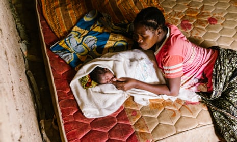 Eva Paulo at home with her baby daughter, Neema Nkwaya, one day old.