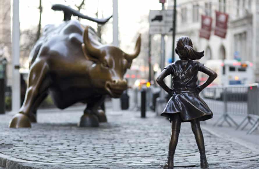 In this March 22, 2017 photo, the Charging Bull and Fearless Girl statues are sit on Lower Broadway in New York. Since 1989 the bronze bull has stood in New York City’s financial district as an image of the might and hard-charging spirit of Wall Street. But the installation of the bold girl defiantly standing in the bull’s path has transformed the meaning of one of New York’s best-known public artworks. Pressure is mounting on the city to let the Fearless Girl stay. (AP Photo/Mark Lennihan)