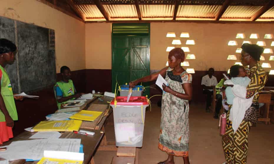 A woman casts her ballot at a polling station in Bangui