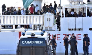 Italian police stand by the Ubaldo Dicotti in Catania, where a group of 177 migrants were prevented from disembarking.