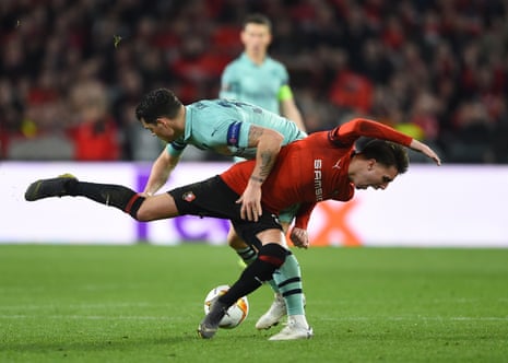 Rennes’ Adrien Hunou is challenged by Granit Xhaka of Arsenal.