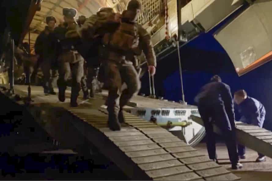 Russian television shows soldiers disembarking a military plane in an airport in Kazakhstan on Thursday.