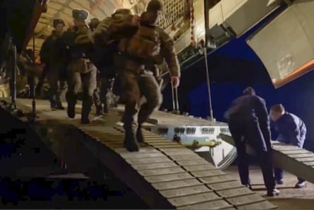 Russian television shows soldiers disembarking a military plane in an airport in Kazakhstan on Thursday.