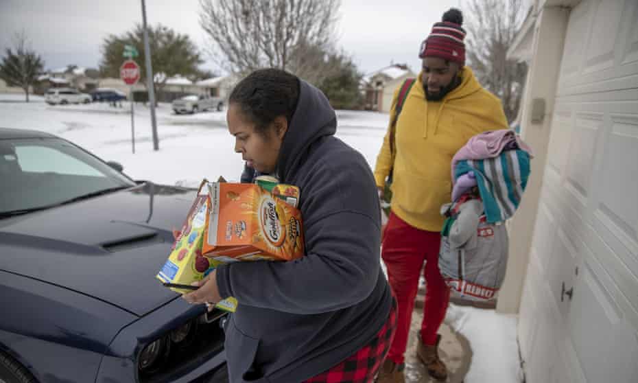 Nena and Howard Mamou take what they can from their home in the Glenwood neighborhood in Hutto, Texas, as they seek a hotel amid power outages.
