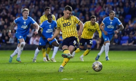 Cameron Brannagan scores from the penalty spot to level for Oxford on the night.