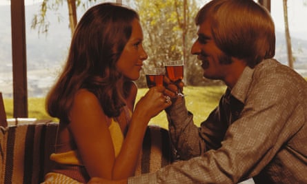 1970s couple drinking wine looking at each other