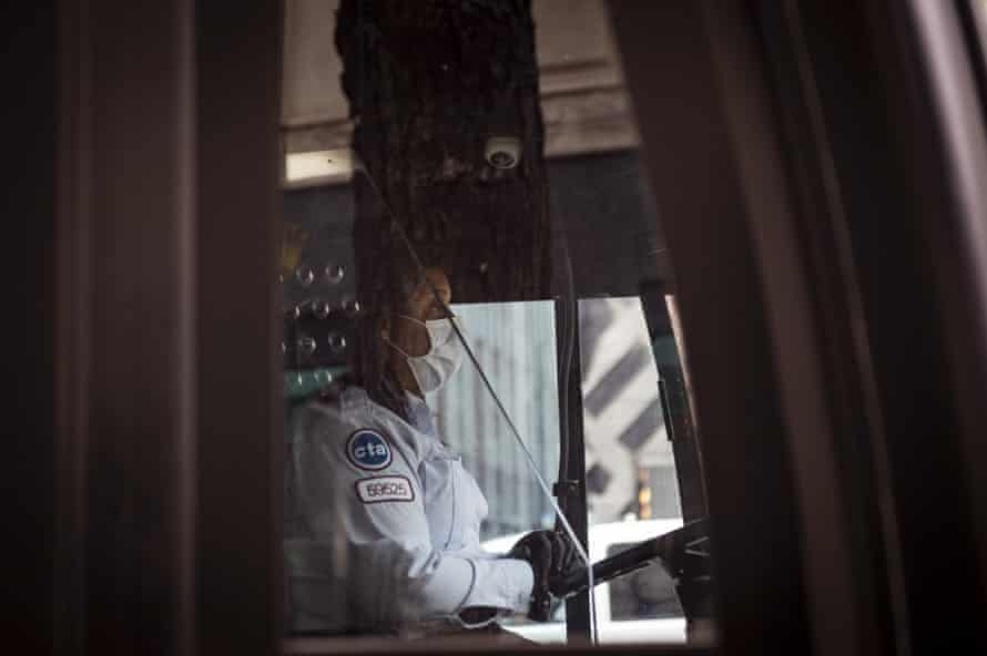 A driver wearing a protective mask operates a Chicago Transit Authority (CTA) bus in Chicago, Illinois, U.S.