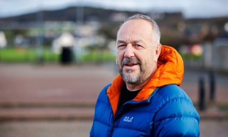 Dave McDade, in a blue jacket with an orange hood