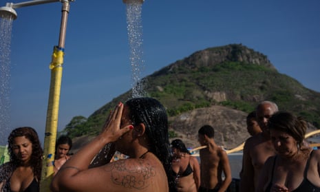 People cool off at Macumba beach, in the west zone of Rio de Janeiro, on 24 September. 