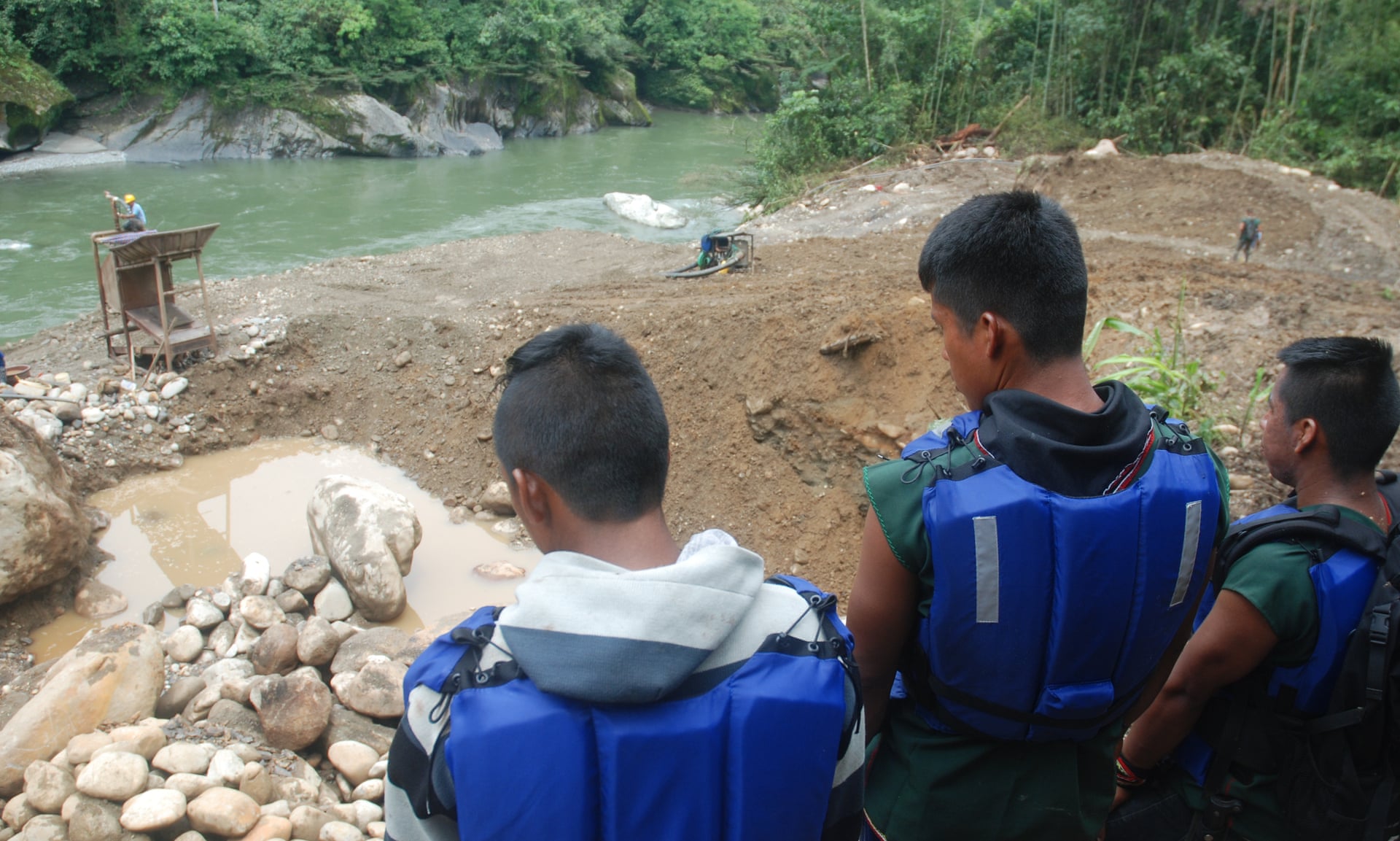 Members of Sinangoe’s guardia indigena look down at the recently-discovered mining site upriver from their community. Photograph: David Hill