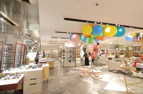 People visit Harvey Nichols department store in London.
