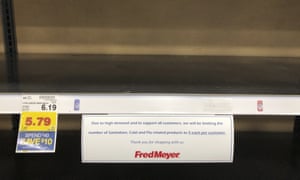 A sign limiting the number of sanitation, cold and Flu products any one customer can buy is seen on a bare shelf at a Fred Meyer store in Anchorage on Friday, March 6, 2020.