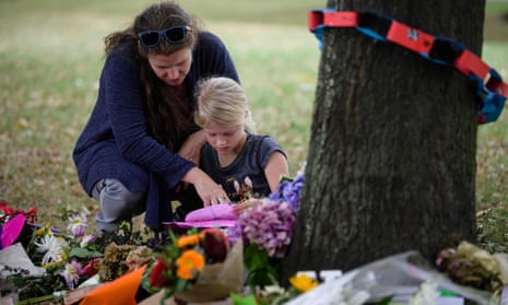 A mother and daughter look at tributes in a park outside the Al Noor Mosque in Christchurch.