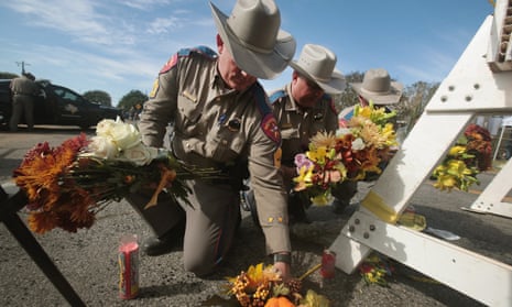 Police move flowers placed at a barricade near the First Baptist church of Sutherland Springs.