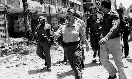 The PLO leader Yasser Arafat inspects bomb damage in the Arab University area of West Beirut in 1982 Israeli bombardment.
