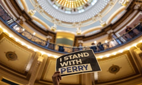 A student holds up a sign that reads ‘I Stand With Perry’ at a gun violence protest in Des Moines, Iowa, on 8 January 2024.