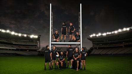 Ruby Tui (top, second right) in a group photo around a rugby goal