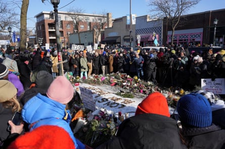People gather on Sunday at a makeshift memorial at the site where Alex Pretti was fatally shot by federal immigration agents in Minneapolis, Minnesota.