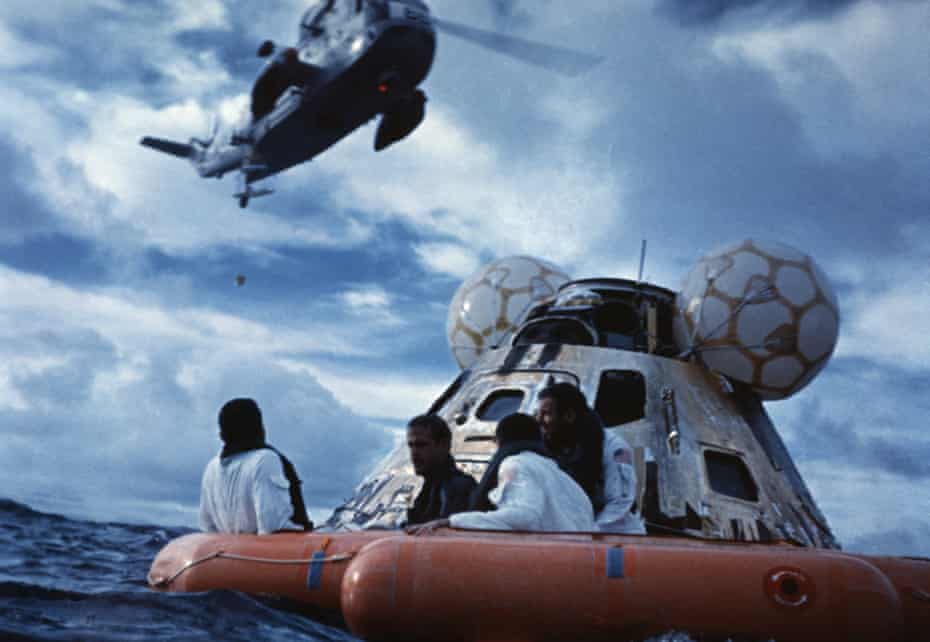 fred haise, jim lovell and jack swigert wait to be picked up by helicopter, 17 april 1970