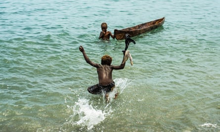 Children swim in water off Savo island, which islanders fear could be leased by a Chinese company.