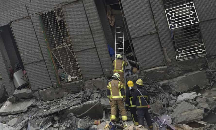 Rescue personnel work at a damaged building