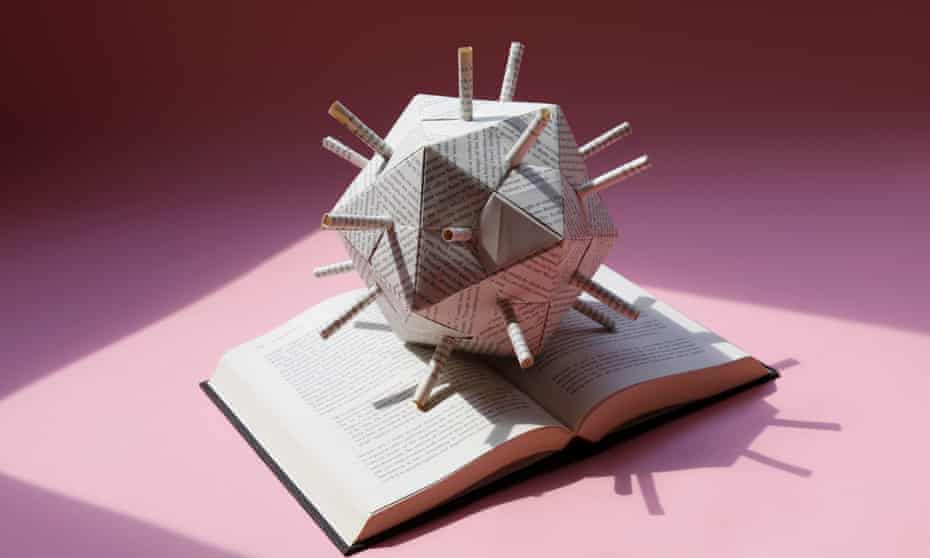 image of an origami globe made from pages of a book on an open book
