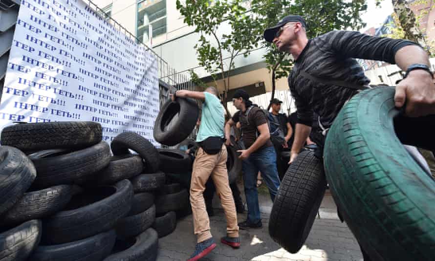 Activists throw tires as they block the entrance of the Inter TV channel in Kiev on the 5 September.