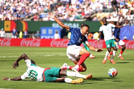 Senegal’s Sadio Mane slides in and fells France’s Kylian Mbappe but no penalty is given.