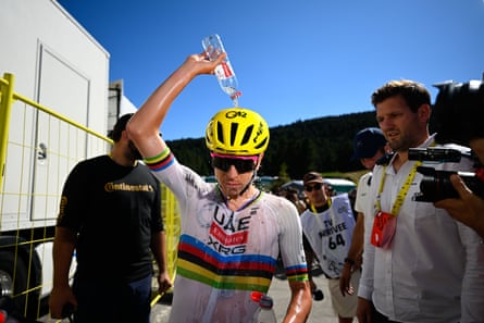 Tadej Pogacar pours h2o complete his caput aft shape three.