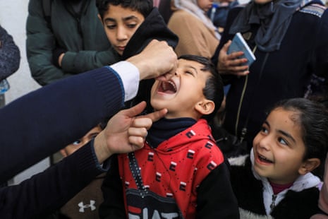 A Palestinian boy is vaccinated against polio, amid a ceasefire between Israel and Hamas, in Gaza City.