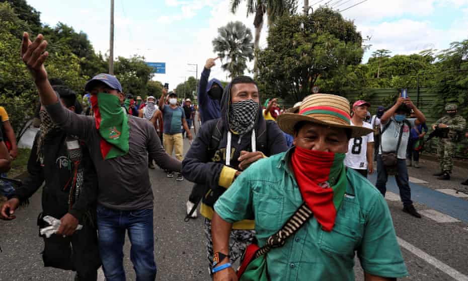 Indigenous people walk down a street during a demonstration today in Cali, Colombia, on Sunday. Colombia, Colombia protests,Cali,Puerto Resistencia, coronavirus pandemic, Harbouchanews