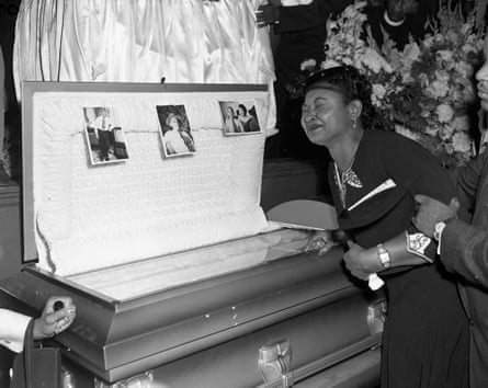 Black and white image of Emmett Till’s mother Mamie beside the open casket of her son, during his funeral in Chicago, Illinois, September 1955