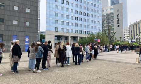 Fans wait to buy merchandise near the Paris La Défense Arena on Thursday morning