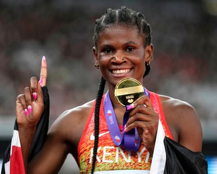 Kenya’s Lilian Odira poses with her gold medal after victory in the women’s 800m final.