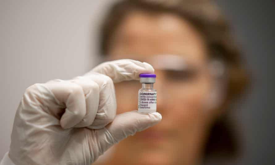 A scientist with a vial of Covid vaccine