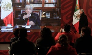 Mexico’s Interior Minister Adan Augusto watches a video message of Mexico’s President Andres Manuel Lopez Obrador, who was diagnosed with coronavirus a second time