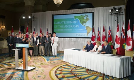 Fellow signatories applaud as Wynne signs a declaration alongside Vermont governor Peter Shumlin, right, and Quebec’s premier, Philippe Couillard, center left, at the Climate Summit of the Americas meeting in Toronto on 9 July.