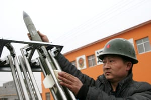 A technician at the local meteorologic department loads a cloud-seeding rocket into a launcher in drought stricken Henan Province, China.
