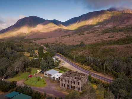 Ruin of old hotel against rolling hills