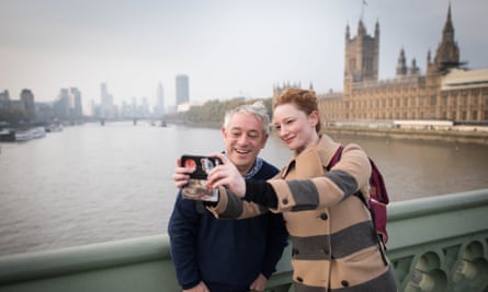 A woman takes a selfie with John Bercow on Westminster Bridge in London.