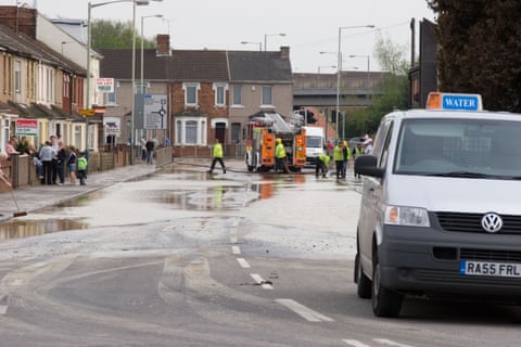 People standing in a slightly flooded street
