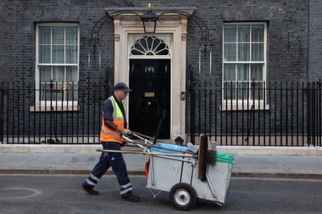A man cleaning the street in Downing Street this morning.
