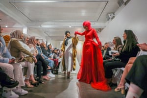 Naima Bulle with a model in a red dress on the modest runway