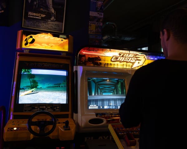 A man playing an arcade game.