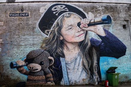 A mural of a girl in a pirate outfit holding a stuffed animal