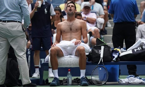 Novak Djokovic takes a break from the heat during his victory over Marton Fucsovics