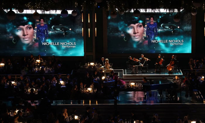 John Legend performs as images of the late Nichelle Nichols are shown during the ‘in memoriam’ segment at the Emmys.