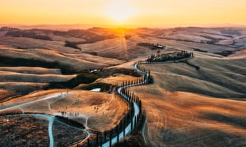 An aerial view of a winding road in the Tuscany landscape, Italy - stock photo<br>Sunset in the Italian countryside