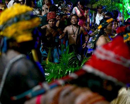 Indigenous people dance during a night-time ceremony