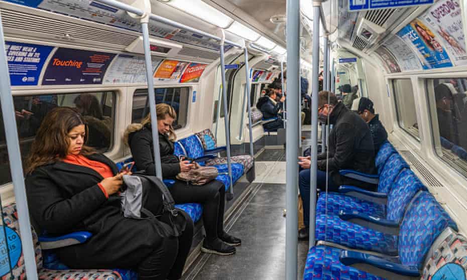 Tube passengers in London on 25 February 2022, the day after the government lifted Covid restrictions.